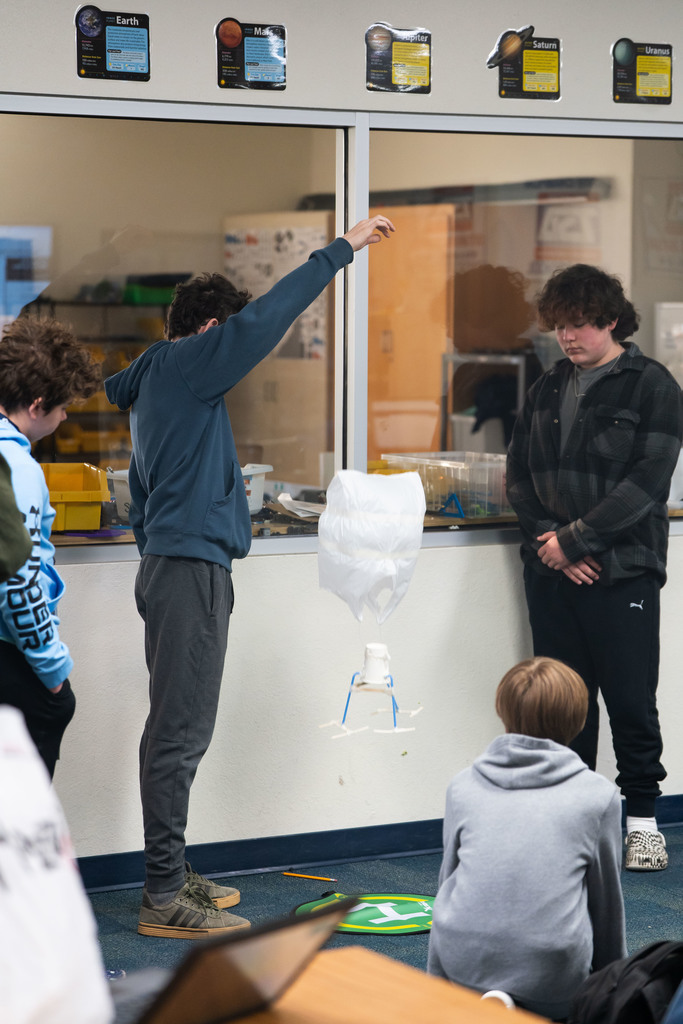 students testing out a science project by dropping it