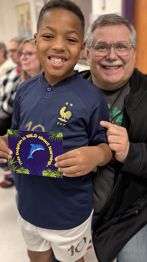 student with teacher receiving an award 