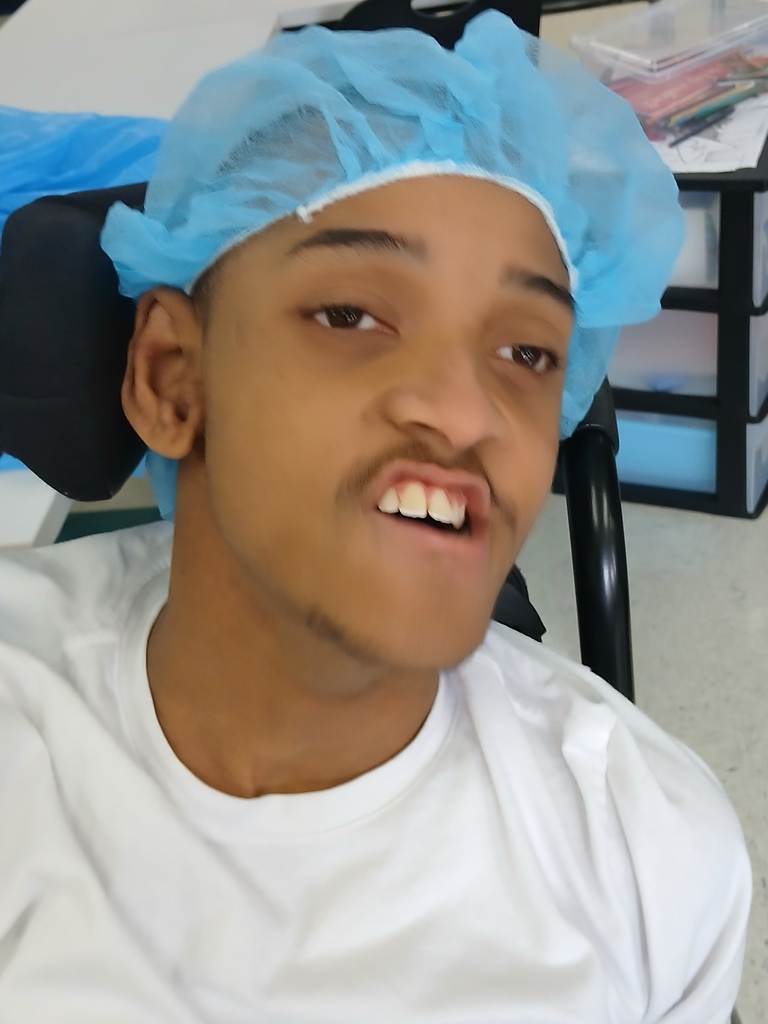 An intern showing some PPE he is wearing. 