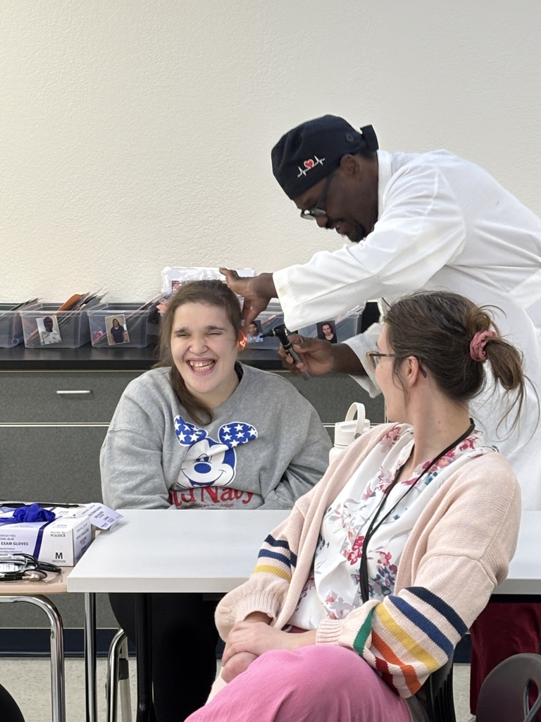 Dr. Brown showing interns how to use an otoscope. 