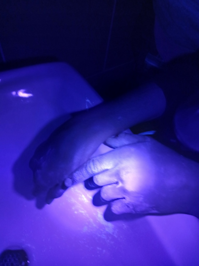 Glow germs being washed away. 