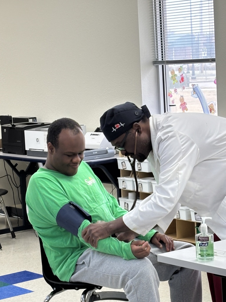Dr. Brown showing interns have to take blood pressure. 