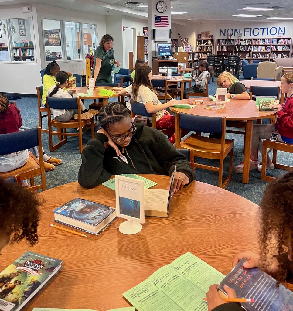 Students explore books of different genres as part of a Book Tasting event in the library.