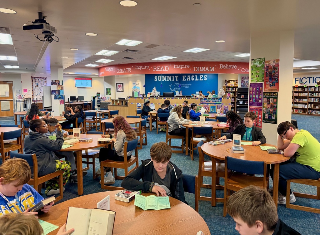 Students explore books of different genres as part of a Book Tasting event in the library.