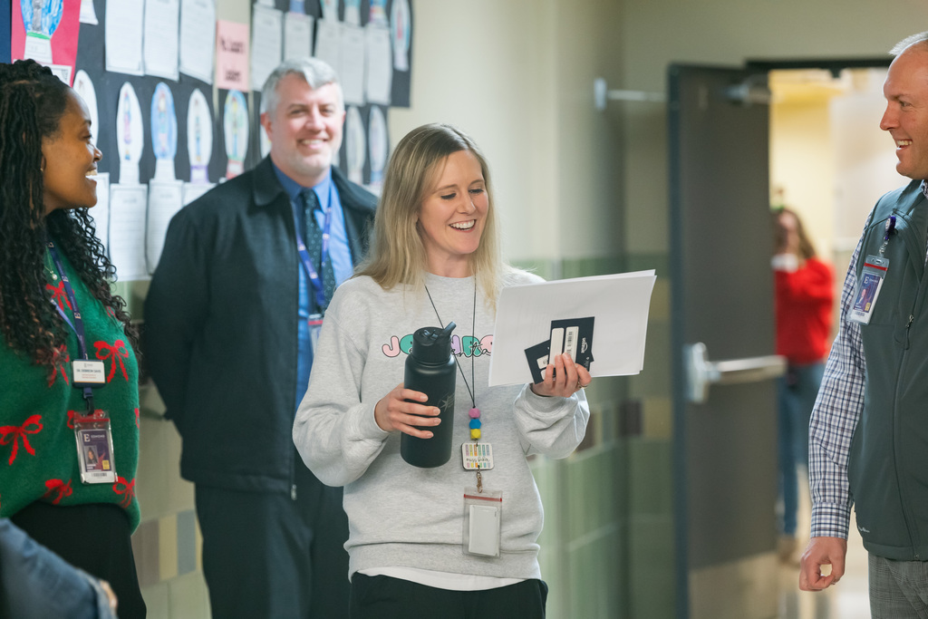 woman looking at her award laughing