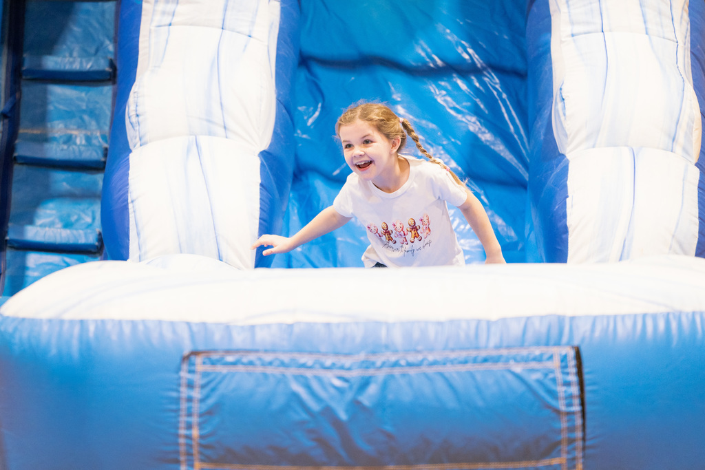 student smiling on a slide