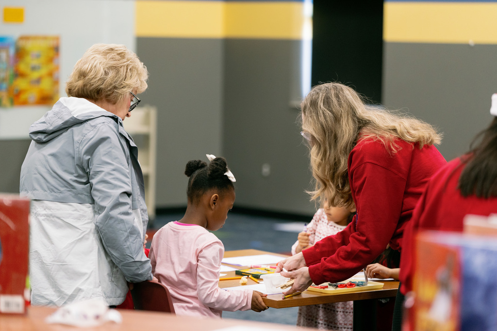 woman helping students