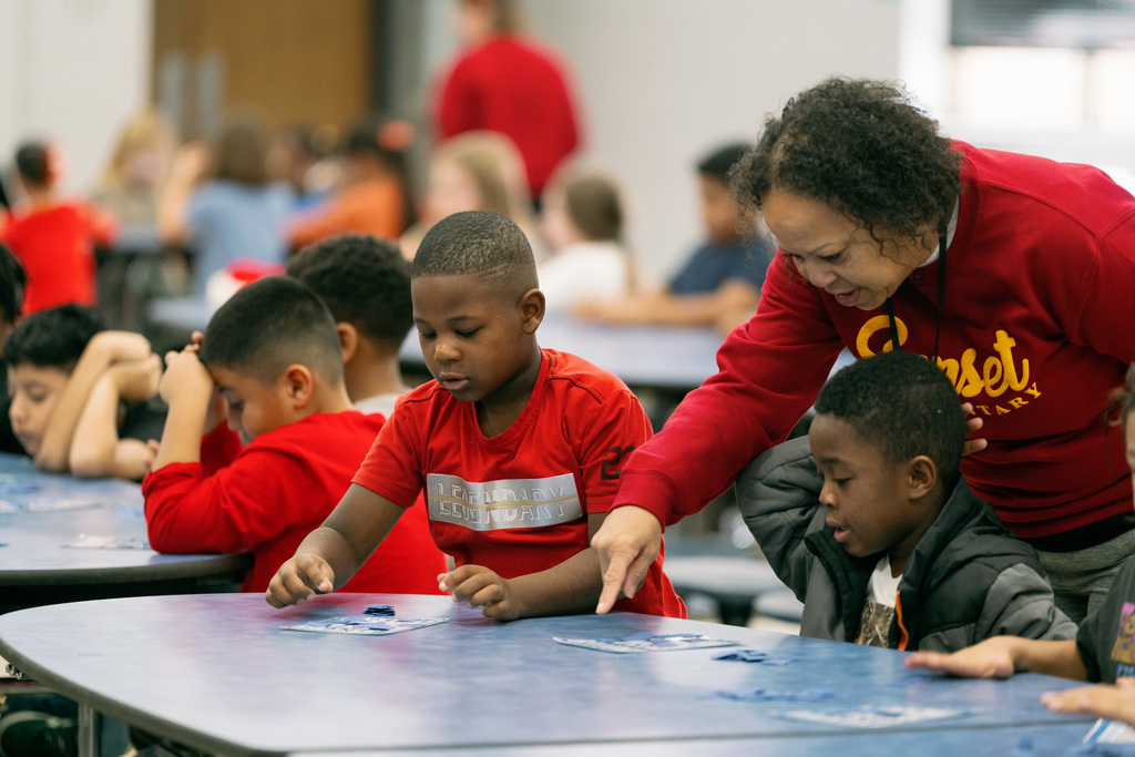 woman helping students