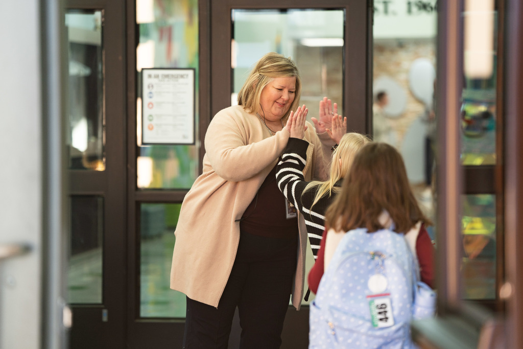 principal giving a high five to student