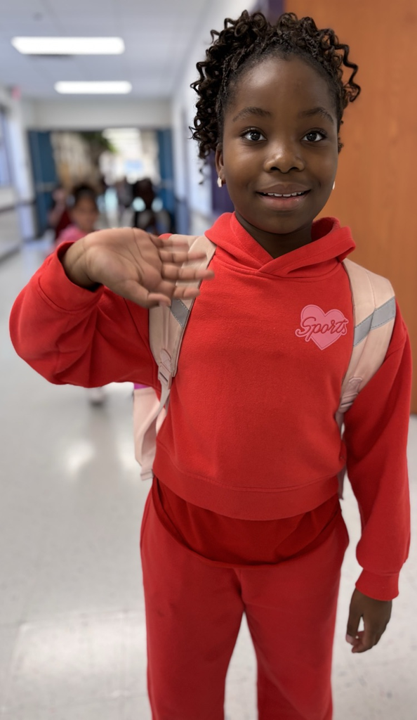 student waving at camera 