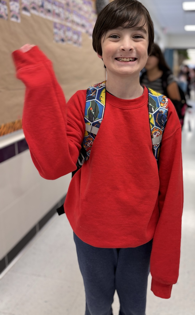 student waving at camera 