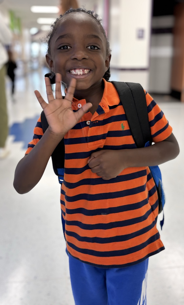 student waving at camera 