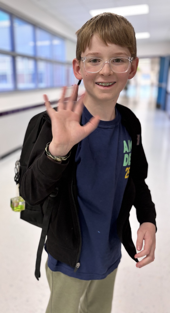 student waving at camera 