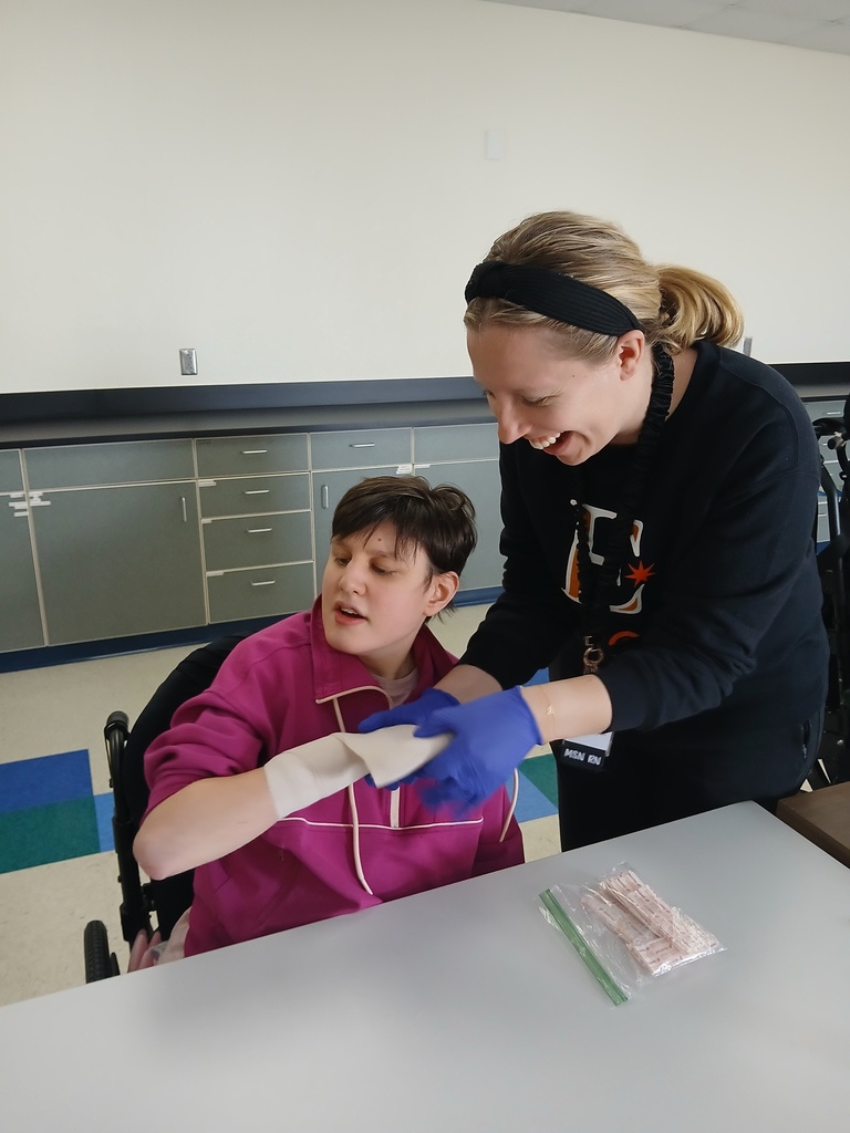 Nurse Jessica teaching how to wrap an injury.