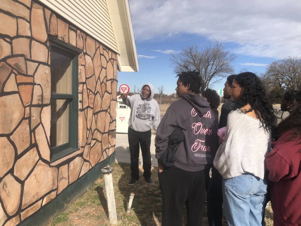 students in a historic building listening to a speaker