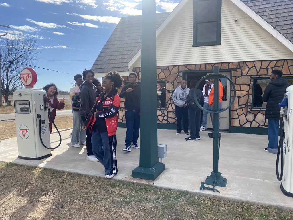 students in a historic building listening to a speaker