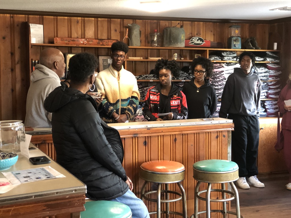 students in a historic building listening to a speaker