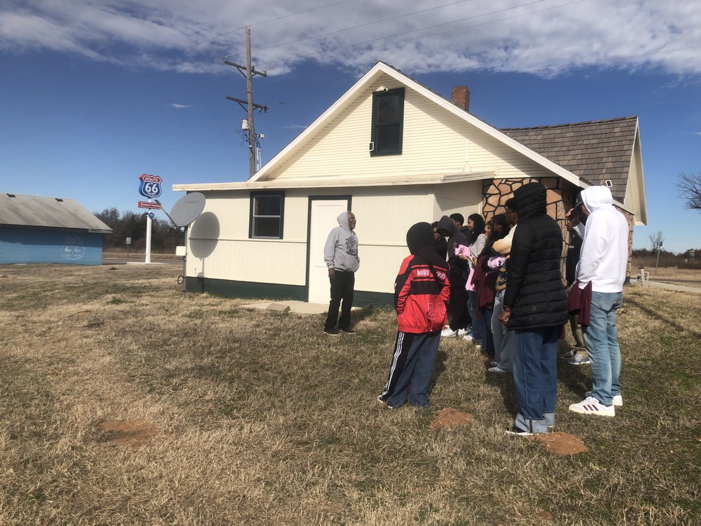 students in a historic building listening to a speaker