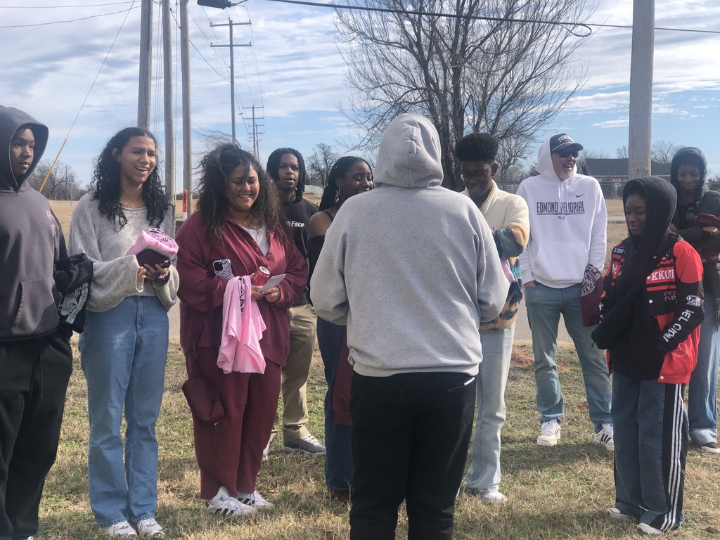 students in a historic building listening to a speaker