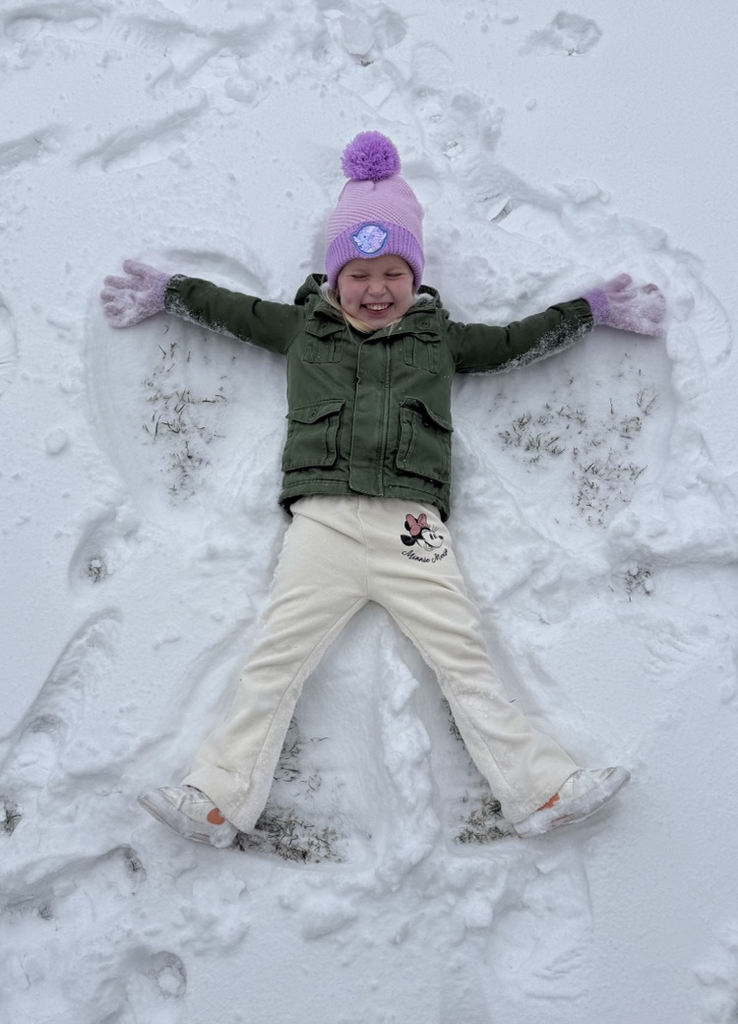 student making a snow angel