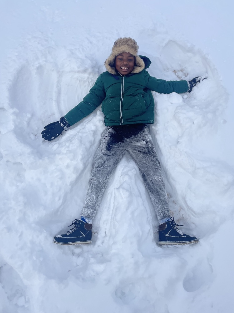 student making snow angel