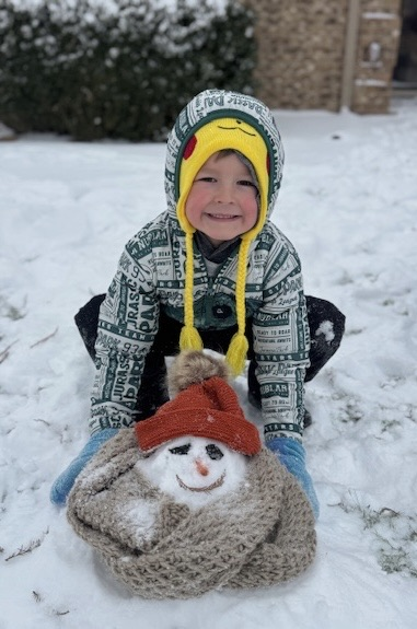 student building snowman