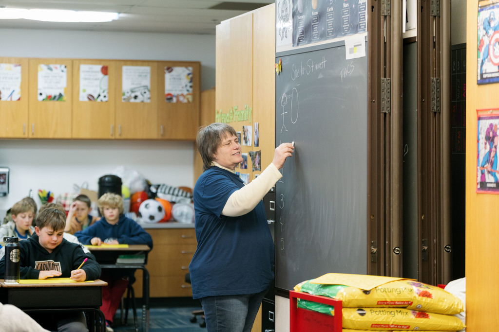 woman writing on board