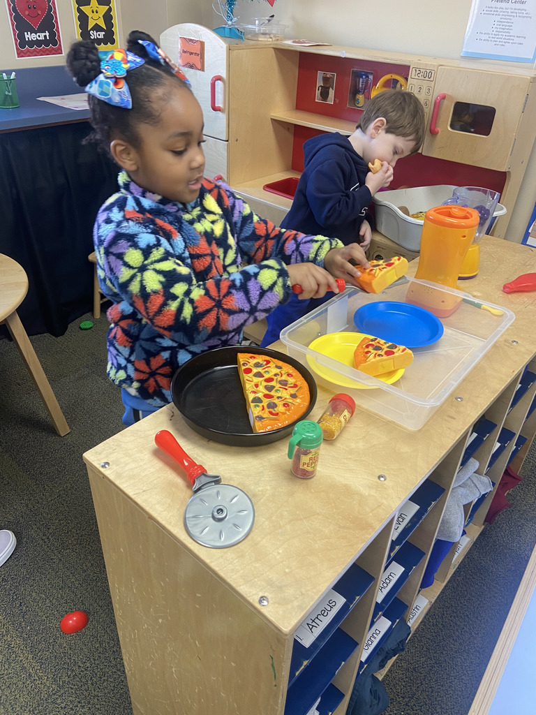 Students pretending to cook a pizza