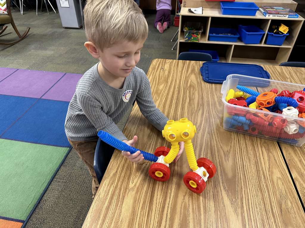 A boy building with tubes