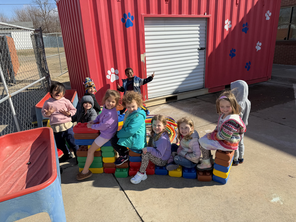 Students building with oversized Legos at recess