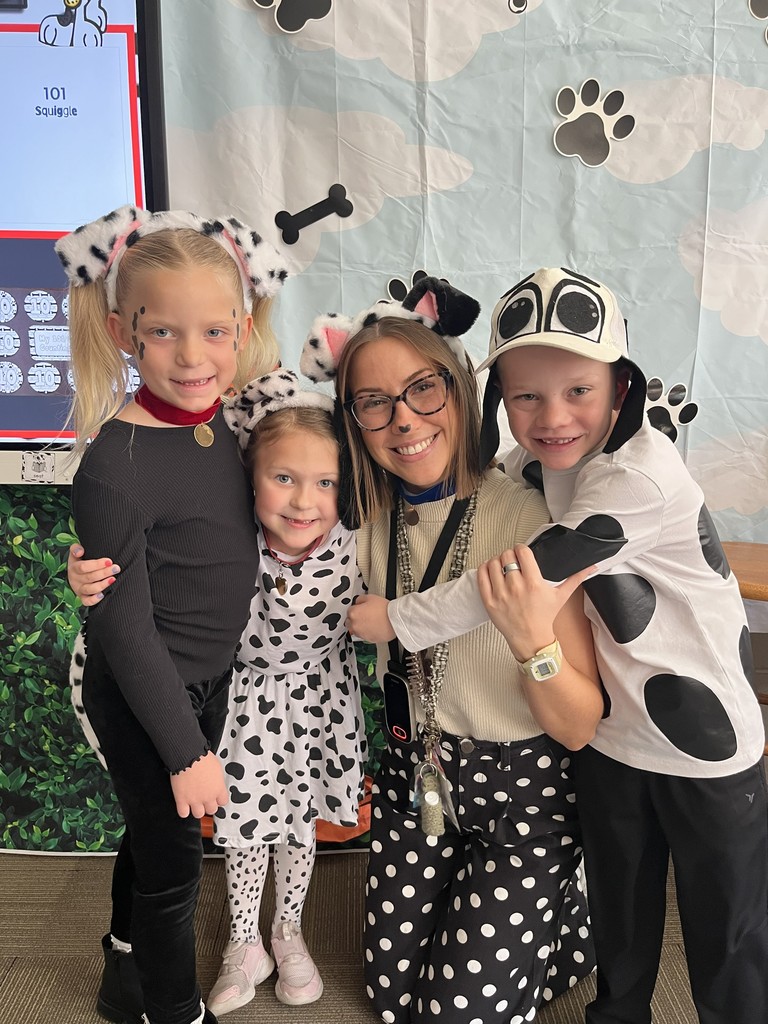 Teacher and student dressed like dalmations for 101st day