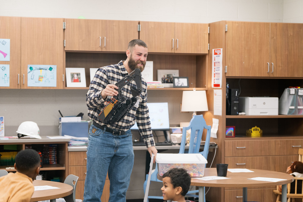 construction worker showing a toy excavator