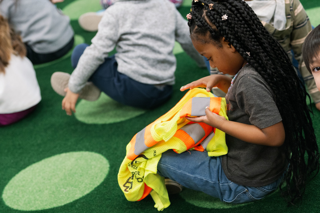 student looking at a safety vest