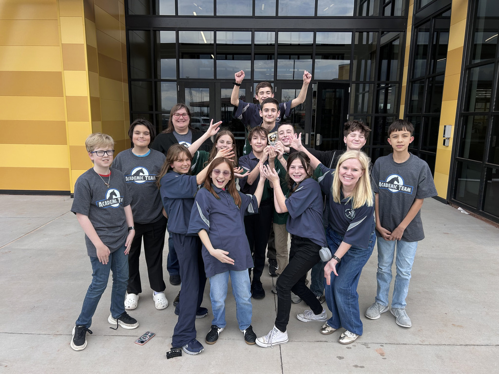 12 teens and 2 teachers  posing with a trophy