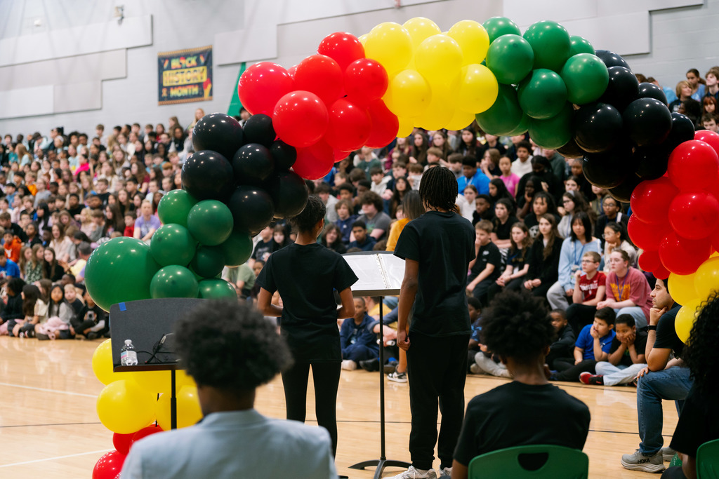 students speaking at an assembly