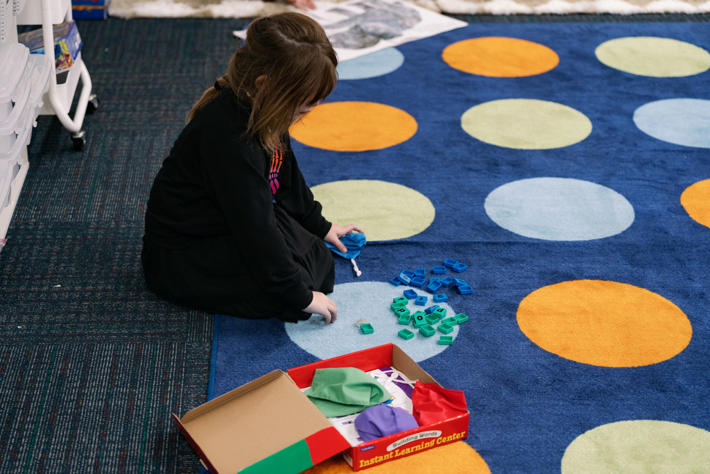 girl playing with letter tiles