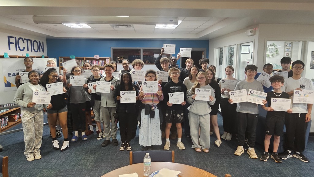 8th grade Eagles Nest recipients stand together smiling and holding their awards.