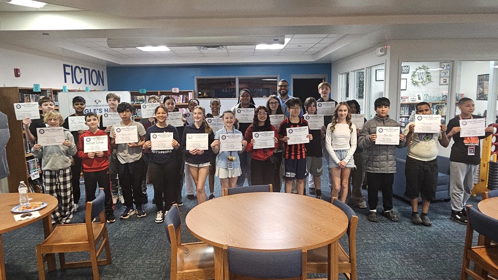 7th grade Eagles Nest recipients stand together smiling and holding their awards.