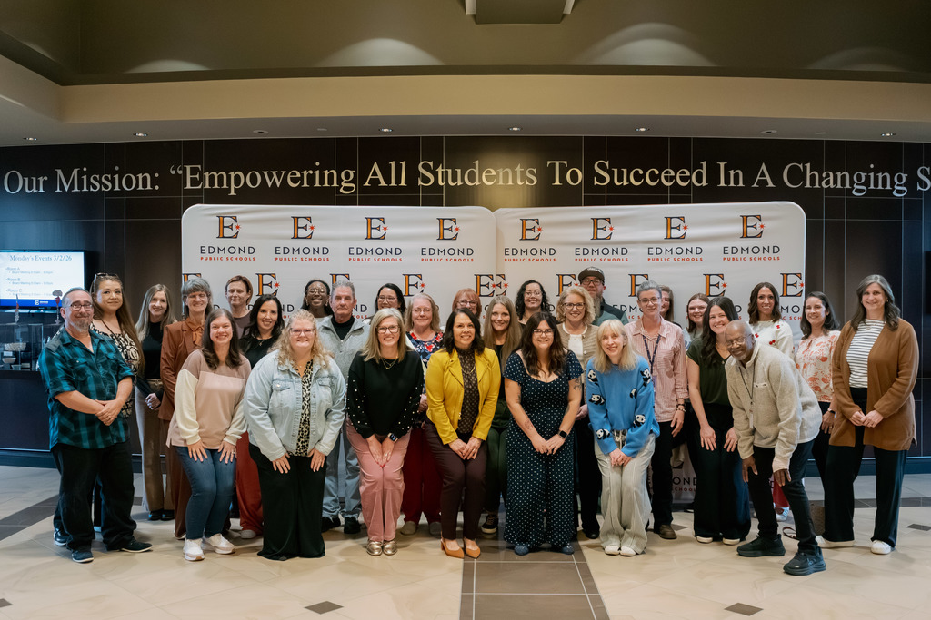 support employees of the year standing against a backdrop