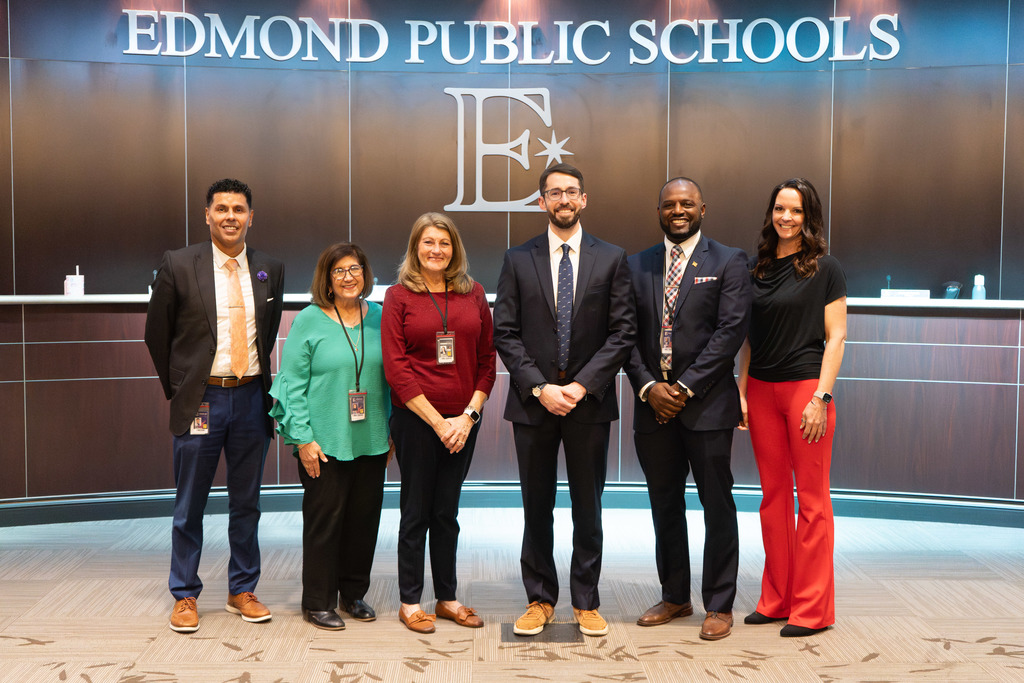 scott goodrich standing with board members at the board meeting