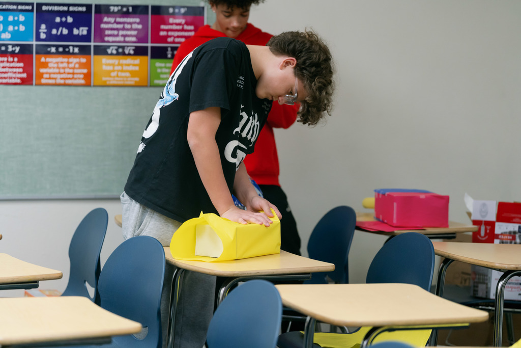 boy taping a box