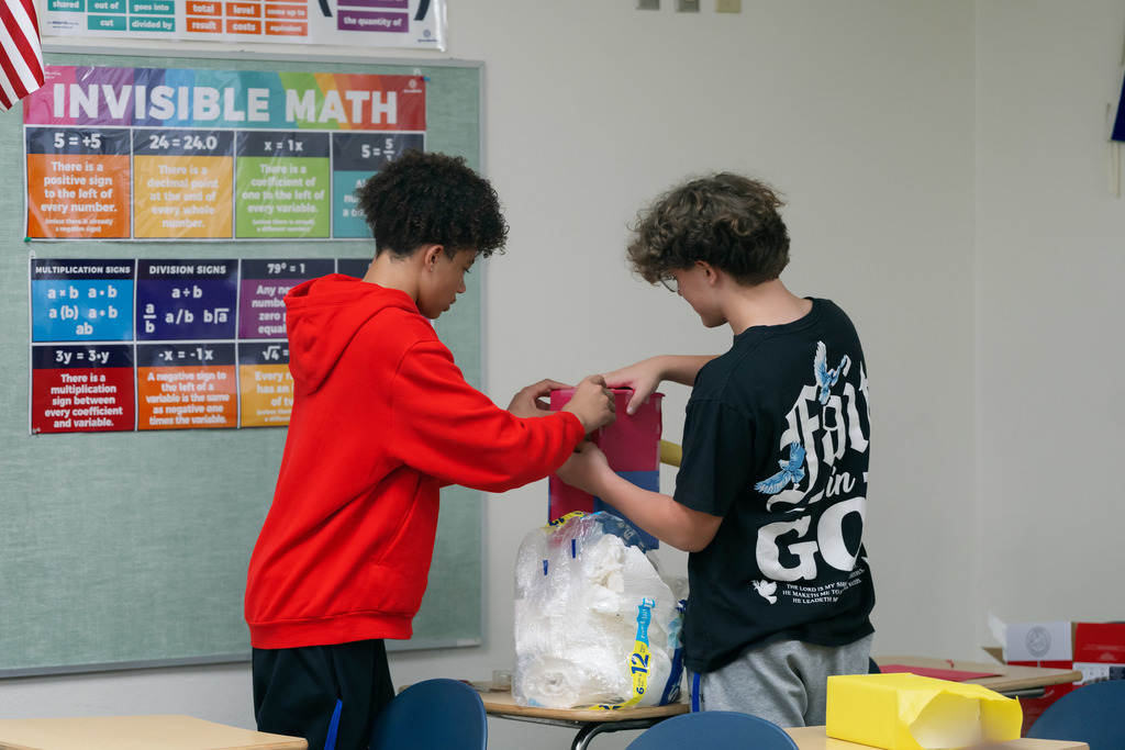 boys holding downa. box