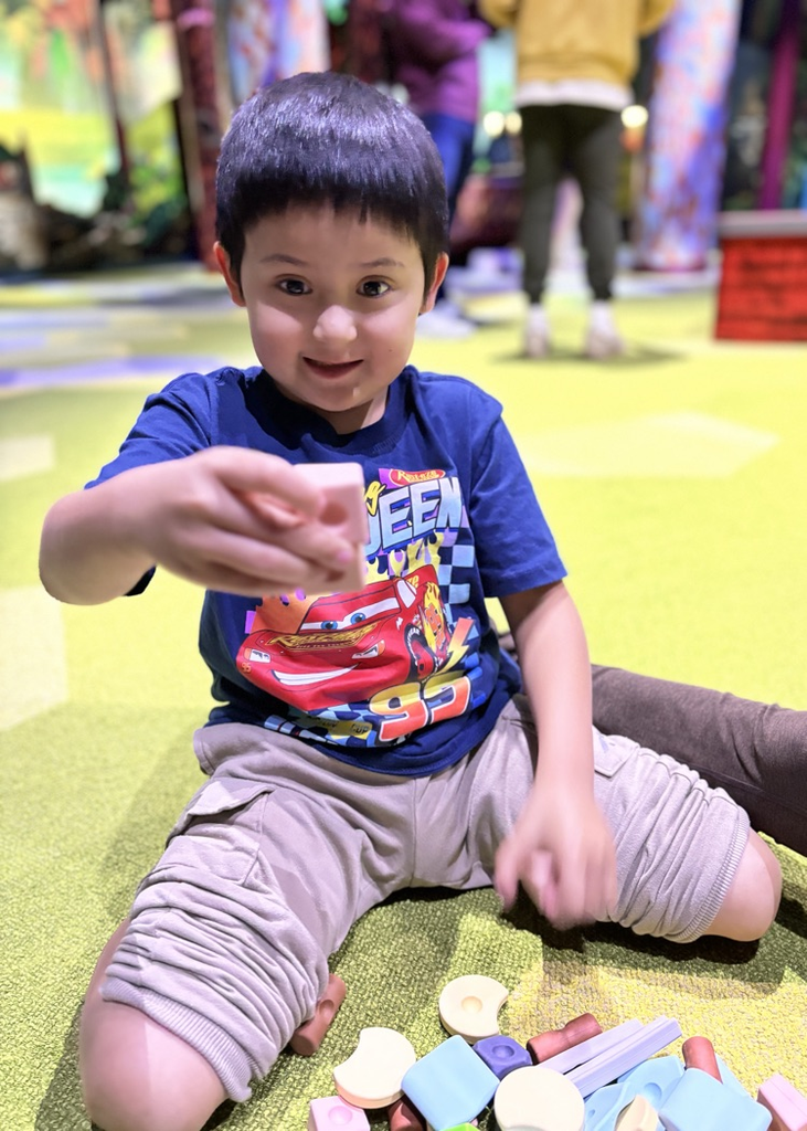 student playing with manipulatives at FAM