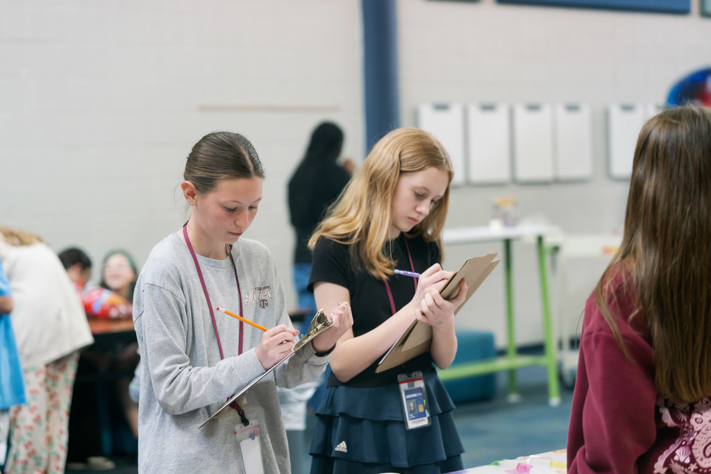 students writing on clipboards
