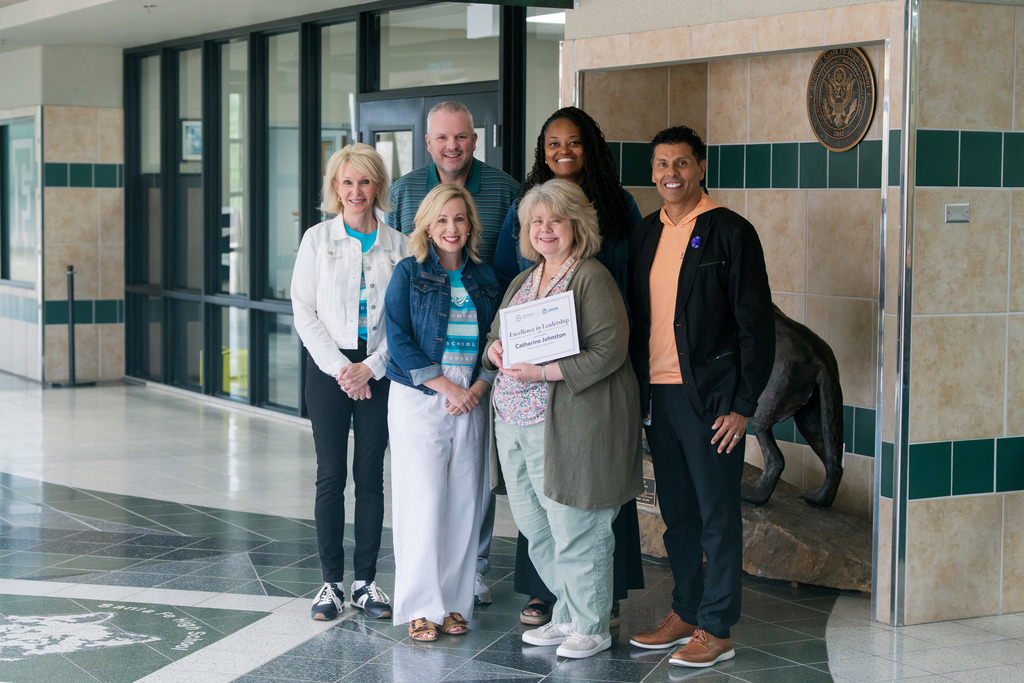 award winners holding their awards
