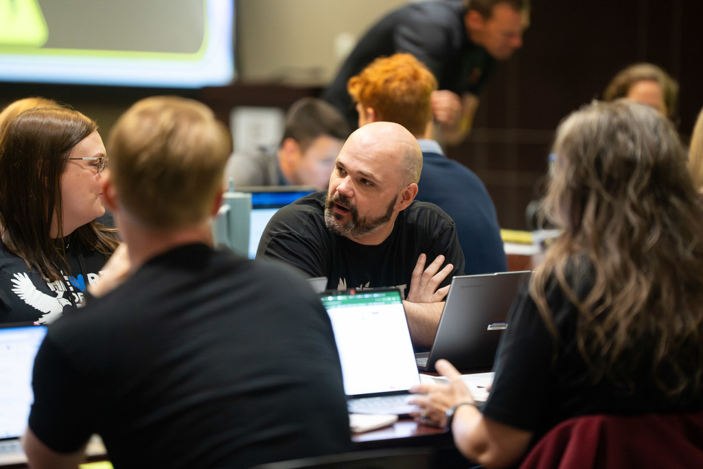 group of teachers talking at a table