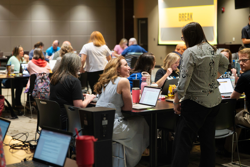 group of teachers talking at a table