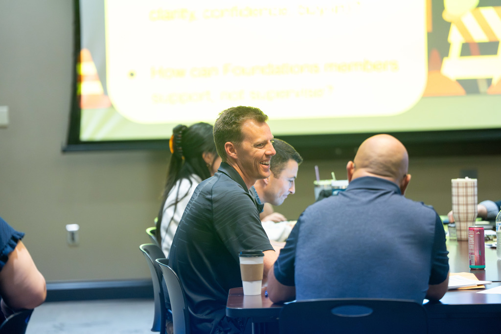 group of teachers talking at a table
