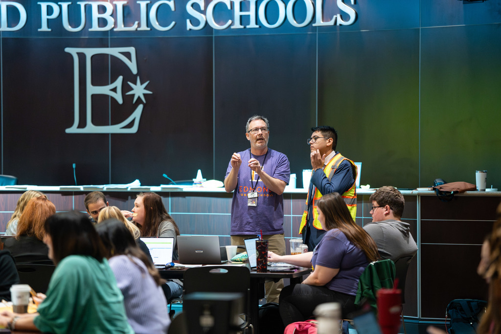 group of teachers talking at a table