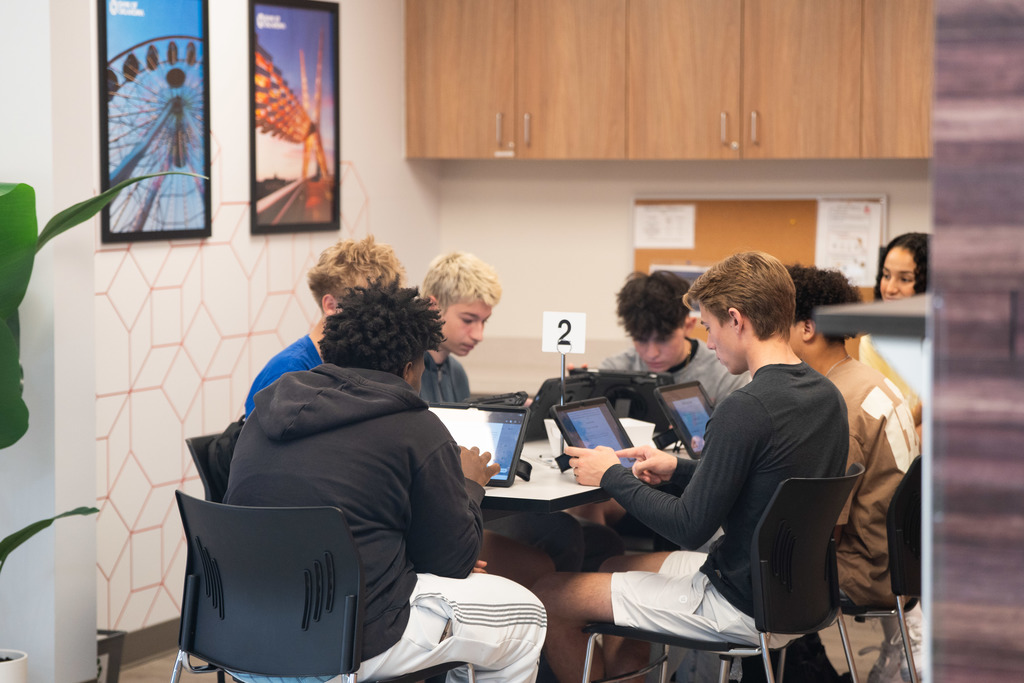 students working on ipads at a desk